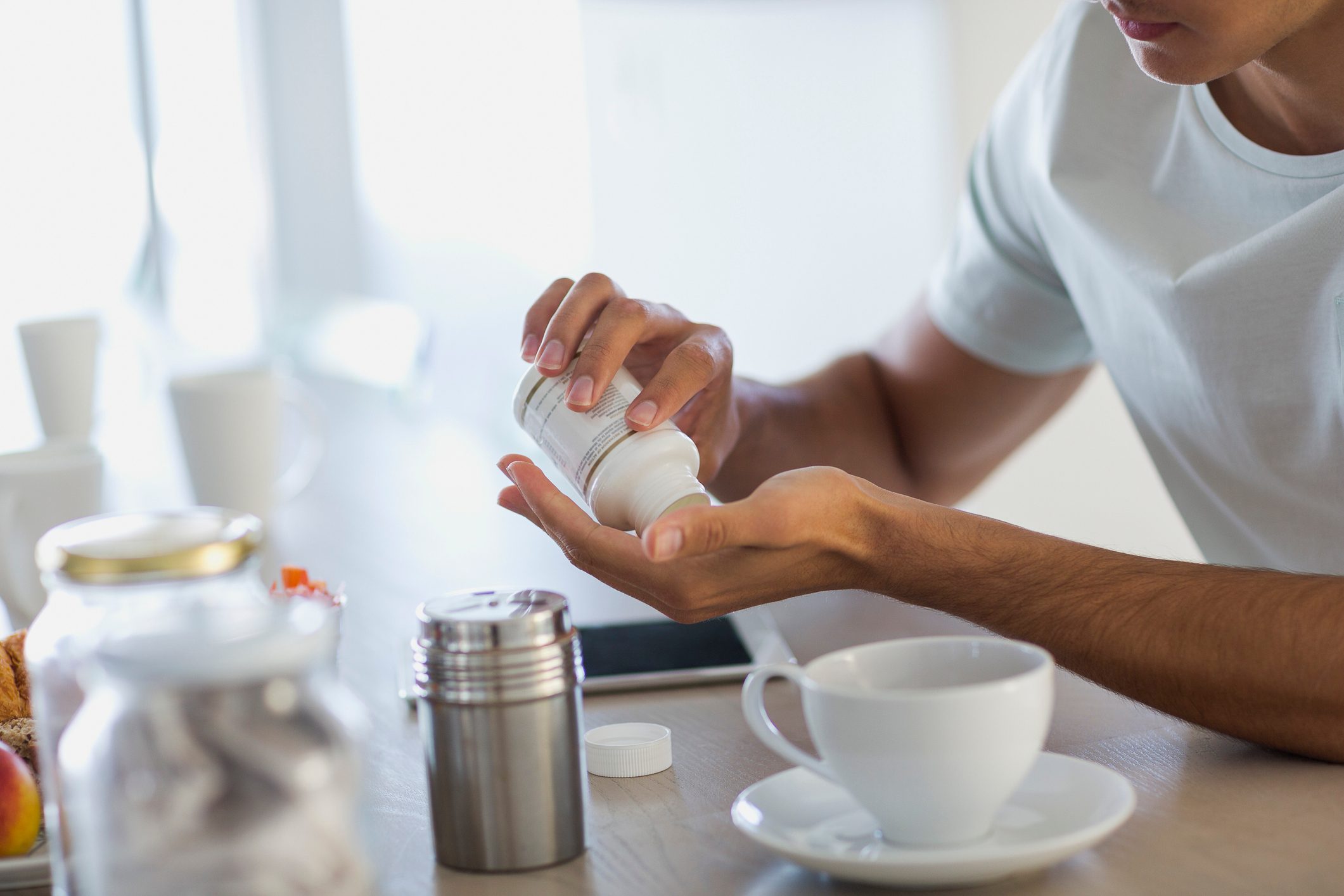 man taking a supplement or vitamin