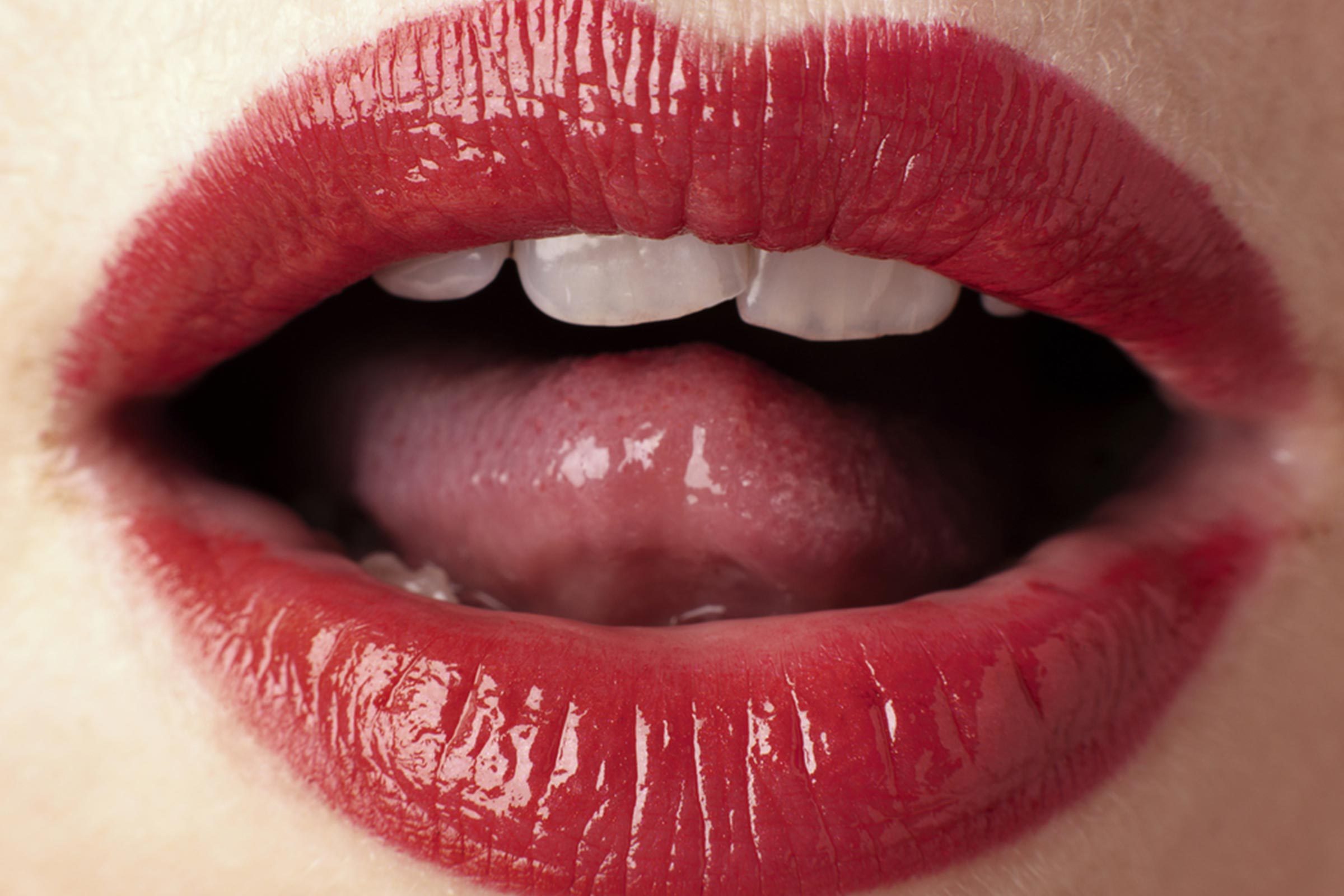 close up of a woman's open mouth, lipstick