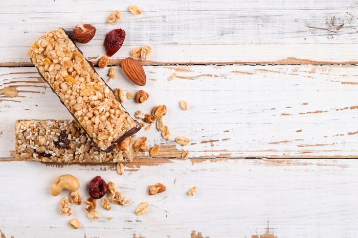 Top view of various healthy granola bars (muesli or cereal bars). Set of energy, sport, breakfast and protein bars isolated on white background