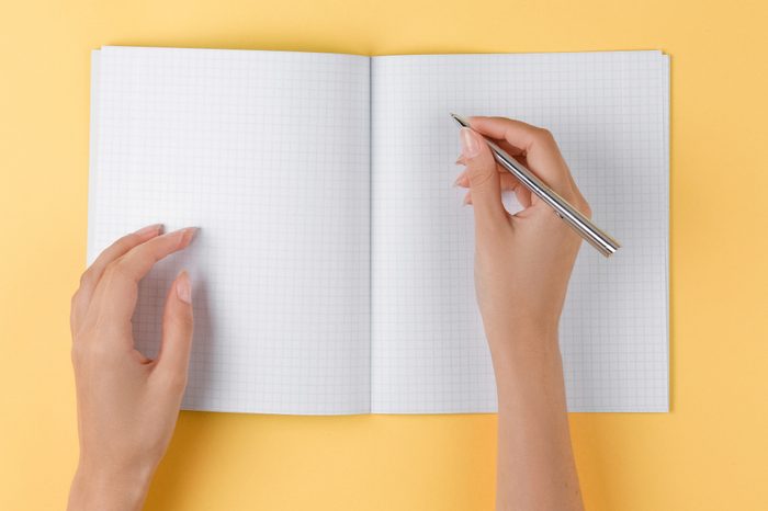 Woman writing in a notebook.