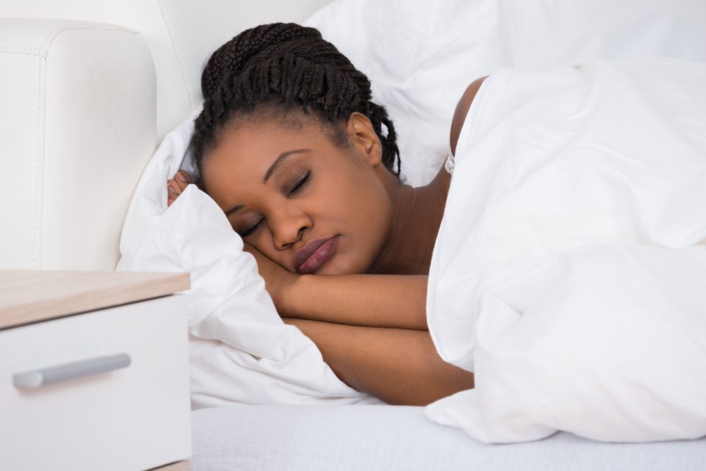 Young Woman Sleeping On Bed