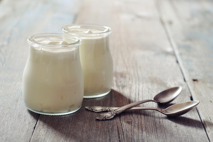 two glasses of yogurt with spoons