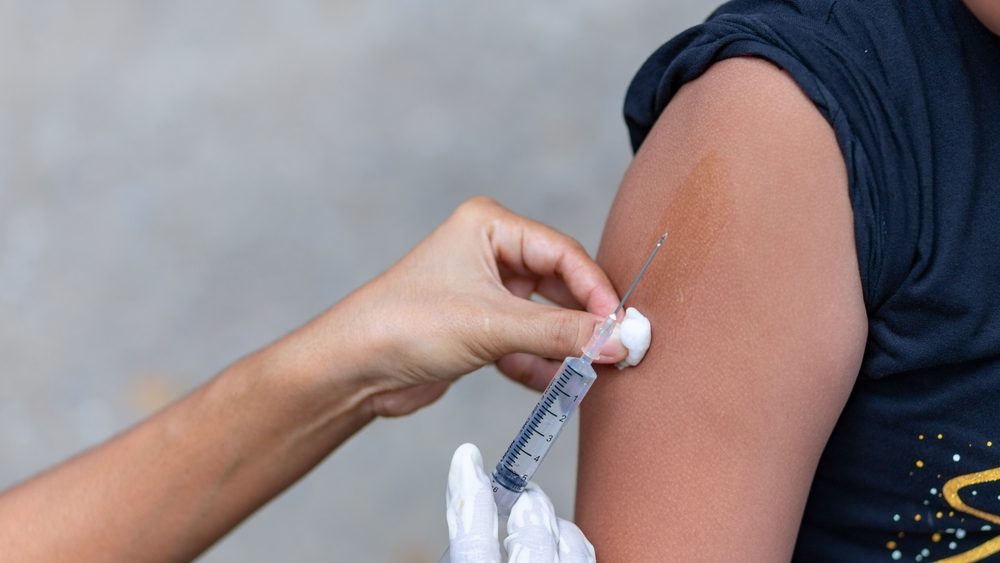 Doctor give injection to boy's arm , healthy and medical concept