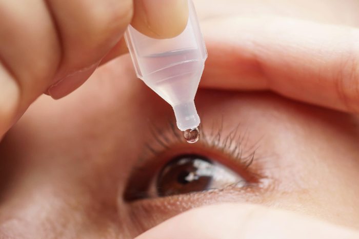 person applying eyedrops