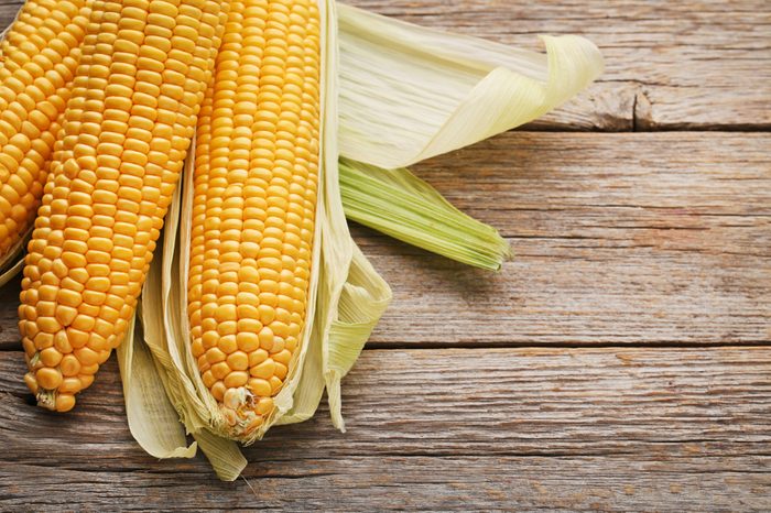 Sweet corns on grey wooden table