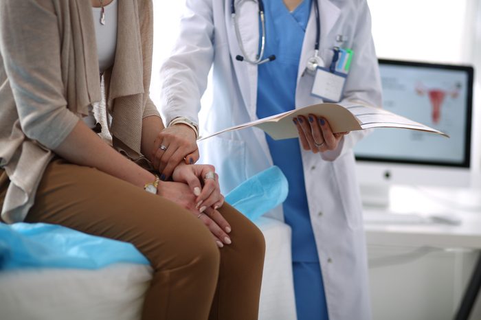 Doctor and patient discussing something while sitting at the table . Medicine and health care concept. Doctor and patient