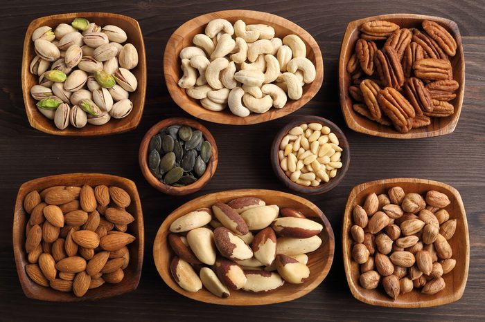 Different kinds of nuts in wooden bowls.