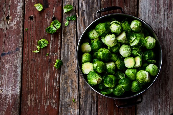 Fresh Brussels sprouts in a bowl on a table.