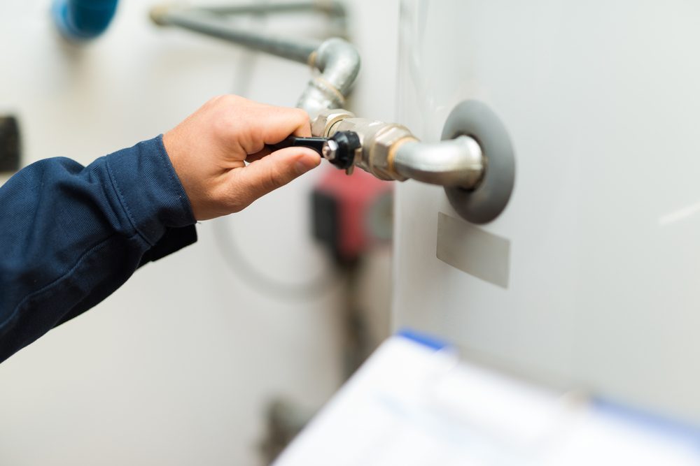 Detail of a technician opening a valve