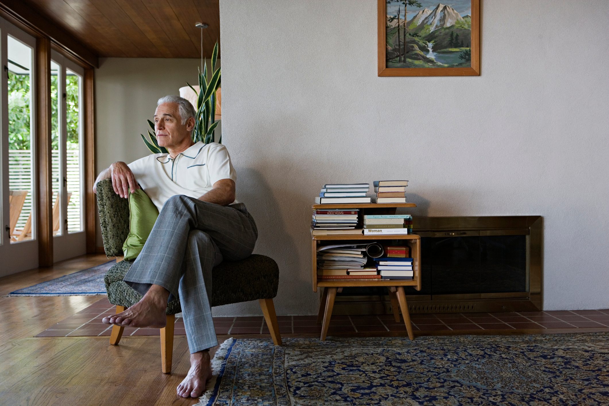 man sitting on chair in house