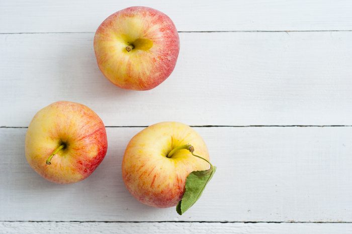 apples on white wood table background