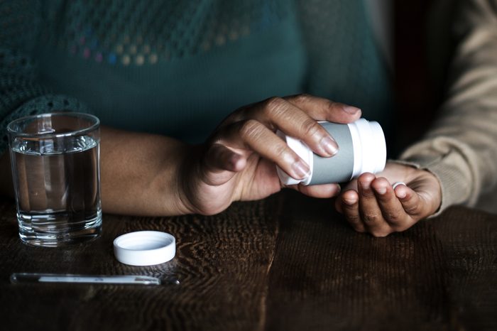 African woman taking her medicine