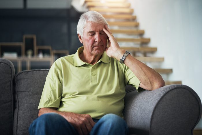 tired man sitting on couch