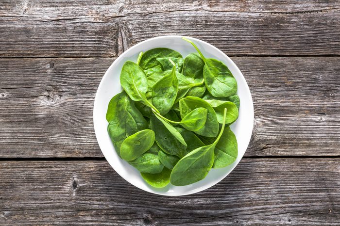 Fresh vegetables, green spinach on plate, healthy diet, vegetarian food concept