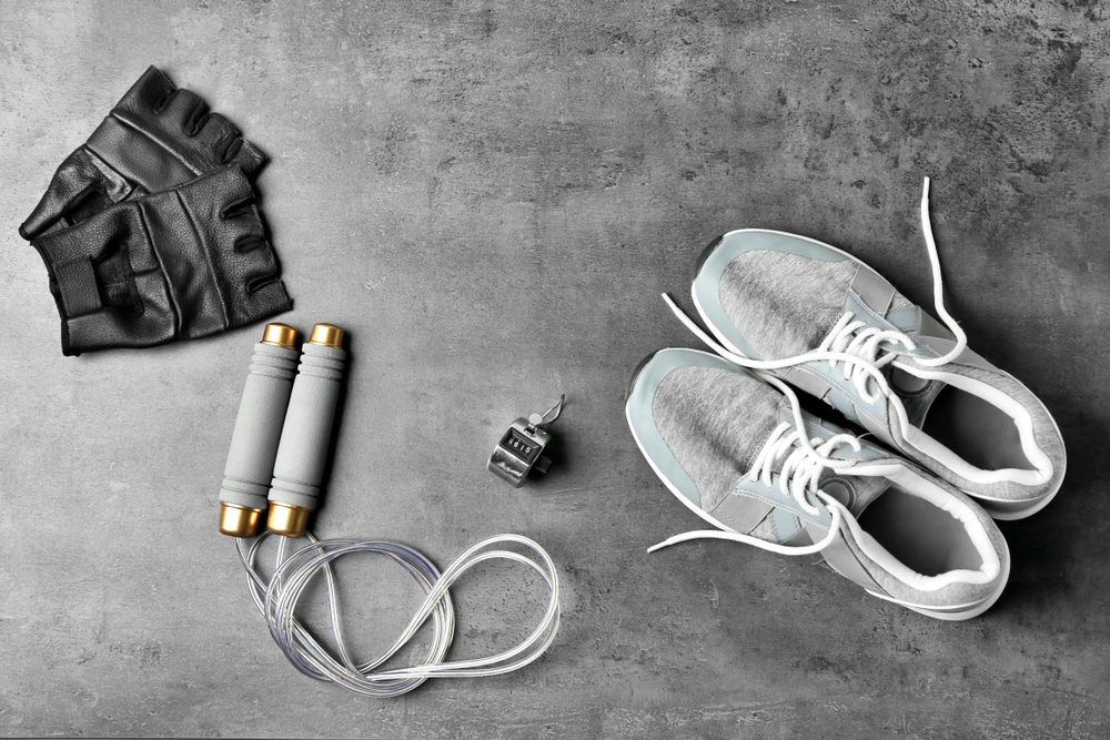 Weight-lifting gloves, jump rope, stopwatch, and sneakers