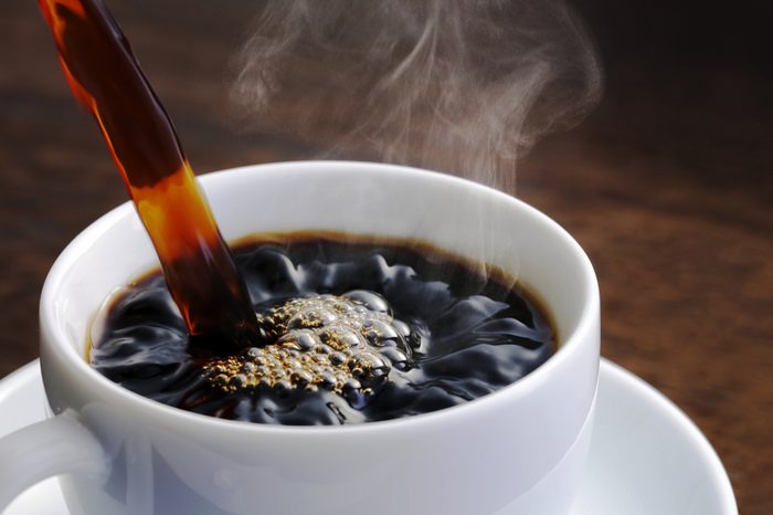 Aachen/ Germany - 07.12.2018: Coffee cup and coffee beans on wooden table