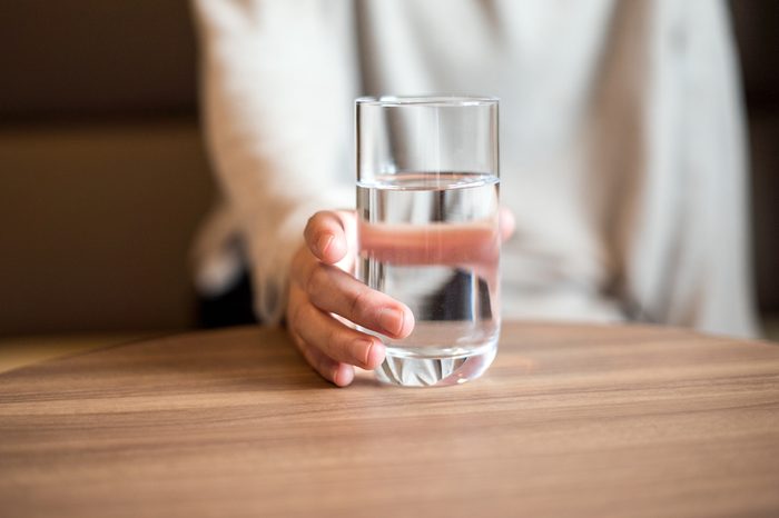 Woman holding a glass of the water