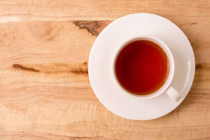 Cup of tea on a wooden background top view.