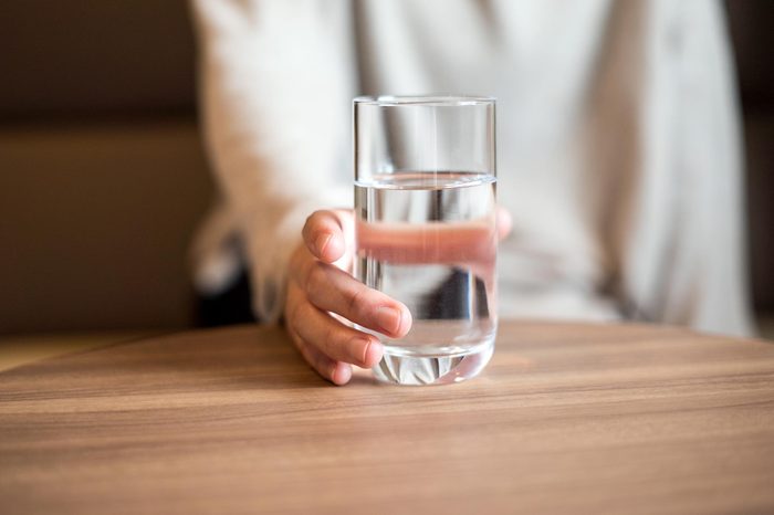 Woman holding a glass of the water