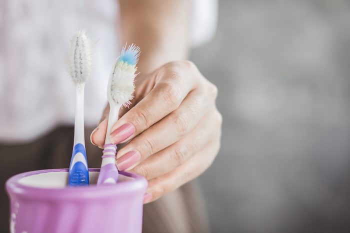 old toothbrush in cup