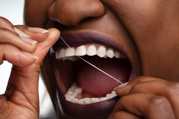 woman flossing her teeth