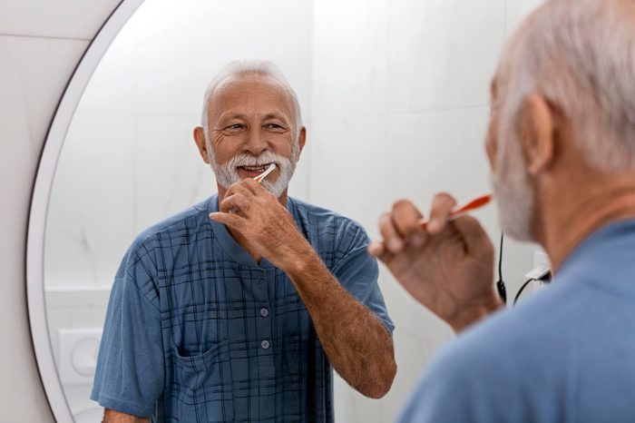 man brushing his teeth