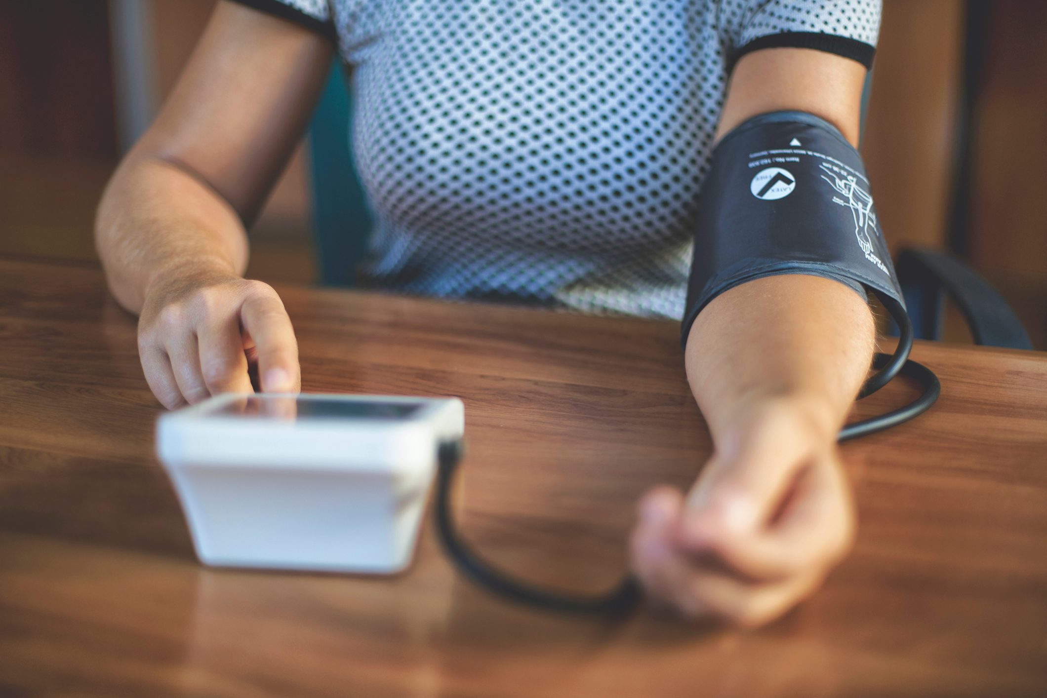 woman checking her blood pressure at home