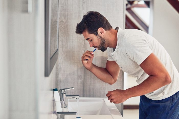 man brushing his teeth