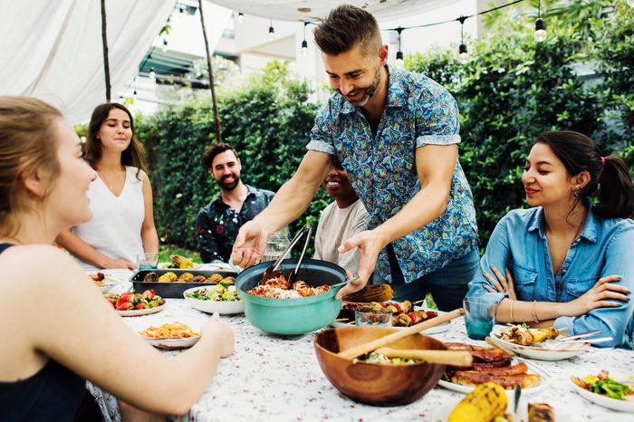 family enjoying dinner outside