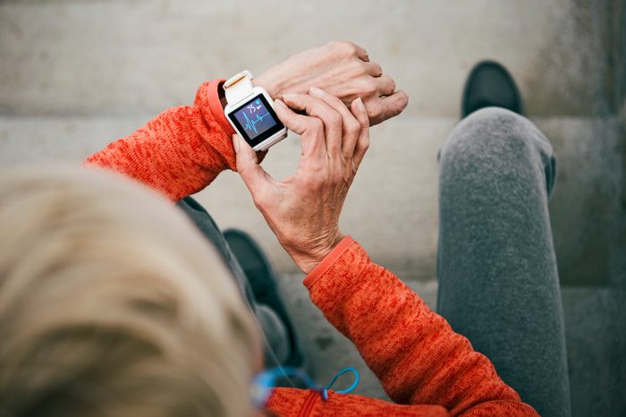 woman checking her heart rate on smart watch