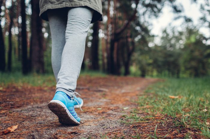 close up of sneaker walking on trail in the woods or forest