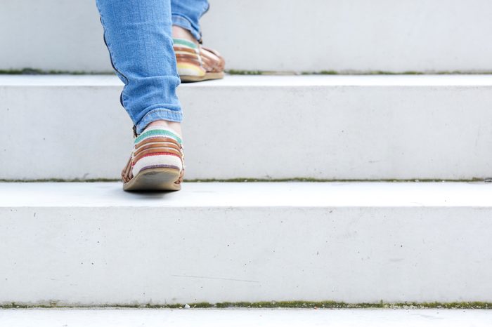 close up on woman walking up stairs