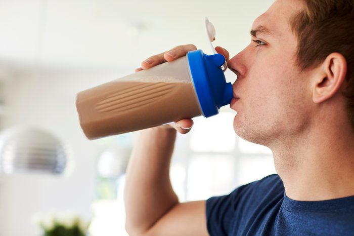 man drinking a protein drink