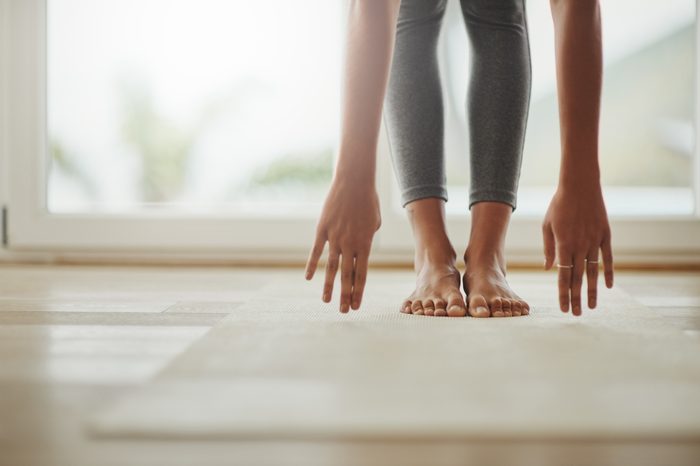 woman stretching at home