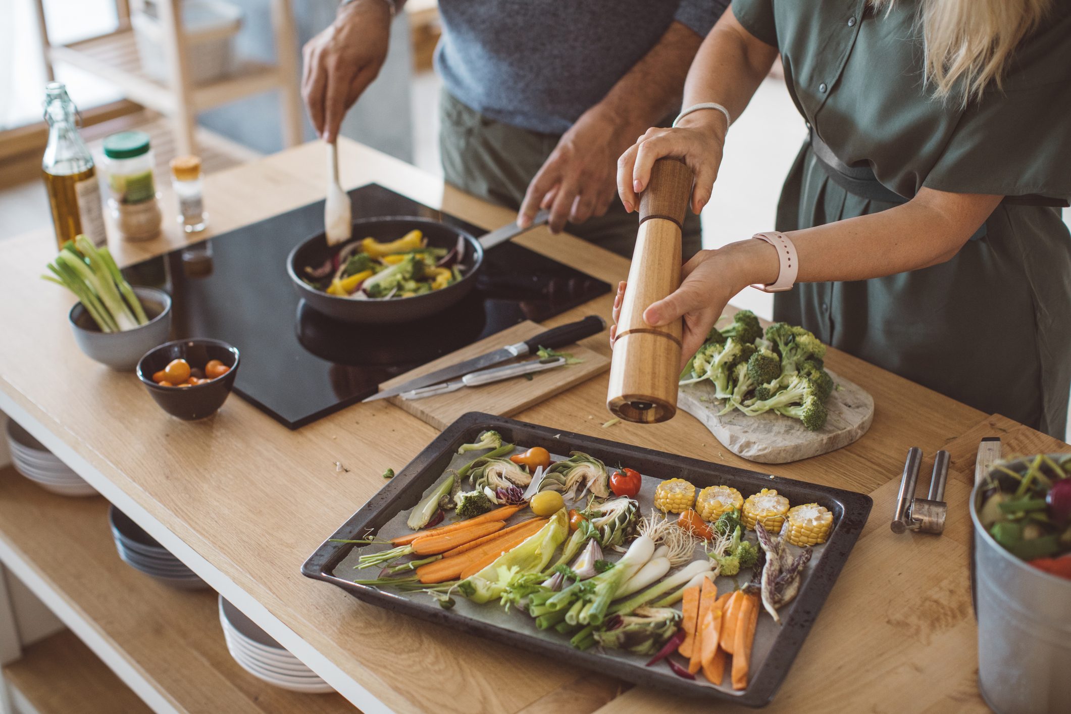 couple cooking healthy meal at home together