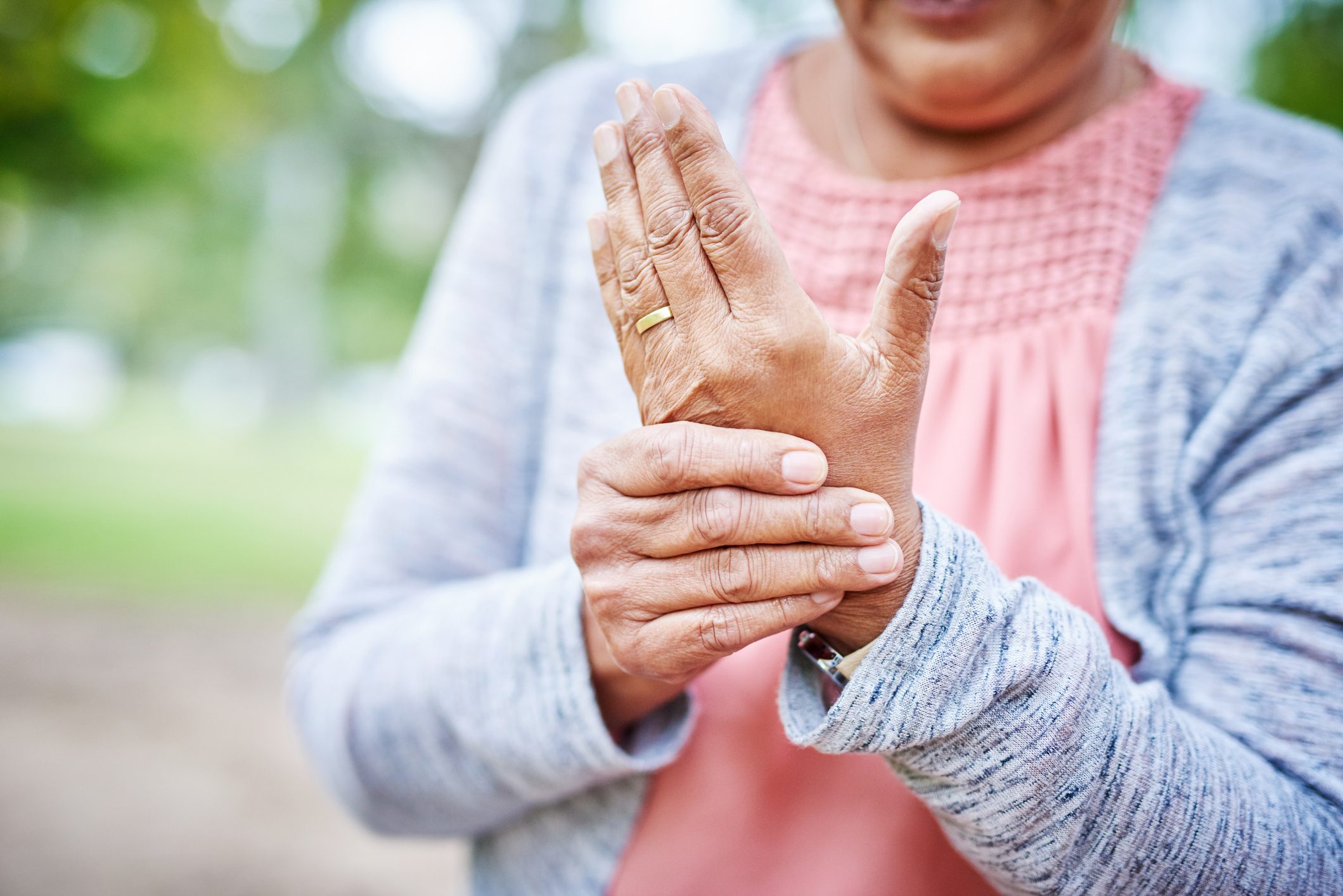 close up of woman suffering from arthritis in her hand