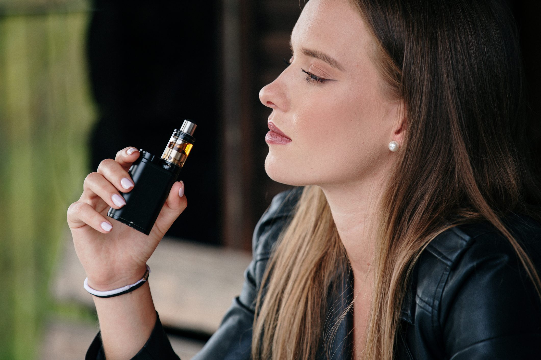 Closeup of woman smoking electronic cigarette