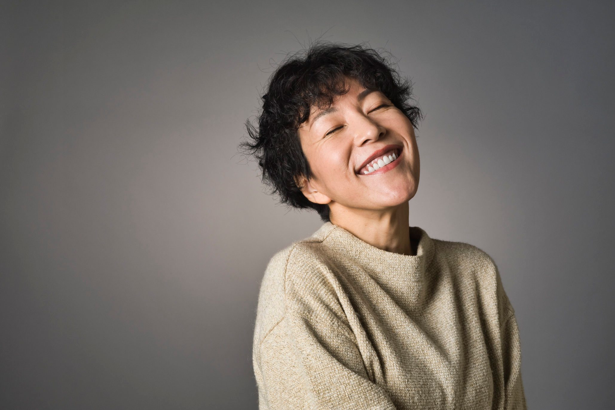 woman smiling with eyes closed