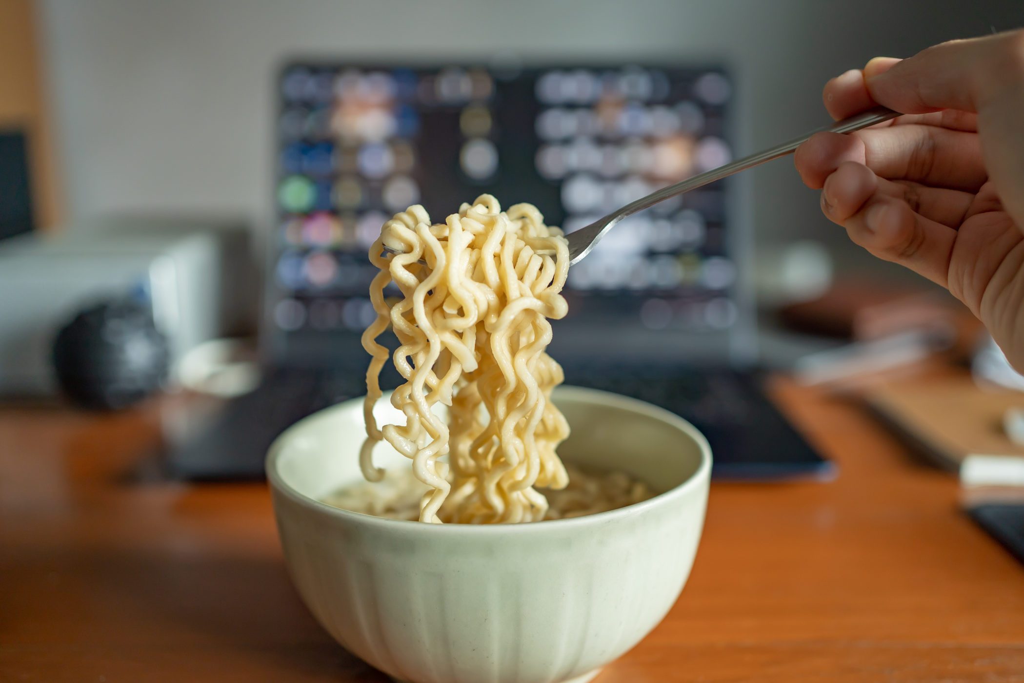 Eating instant noodle on a working table