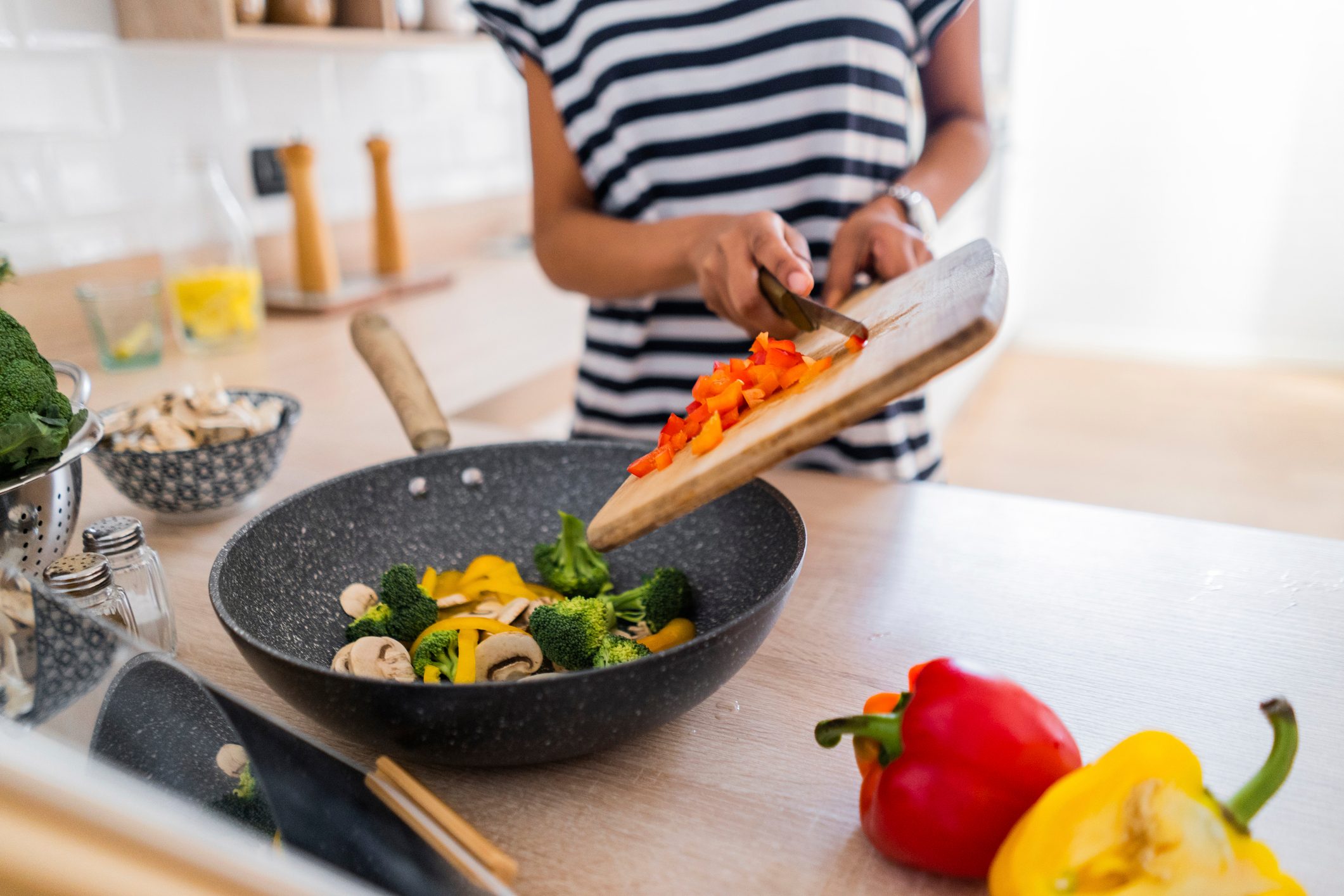 Close-up of young woman with tablet cooking in kitchen at home