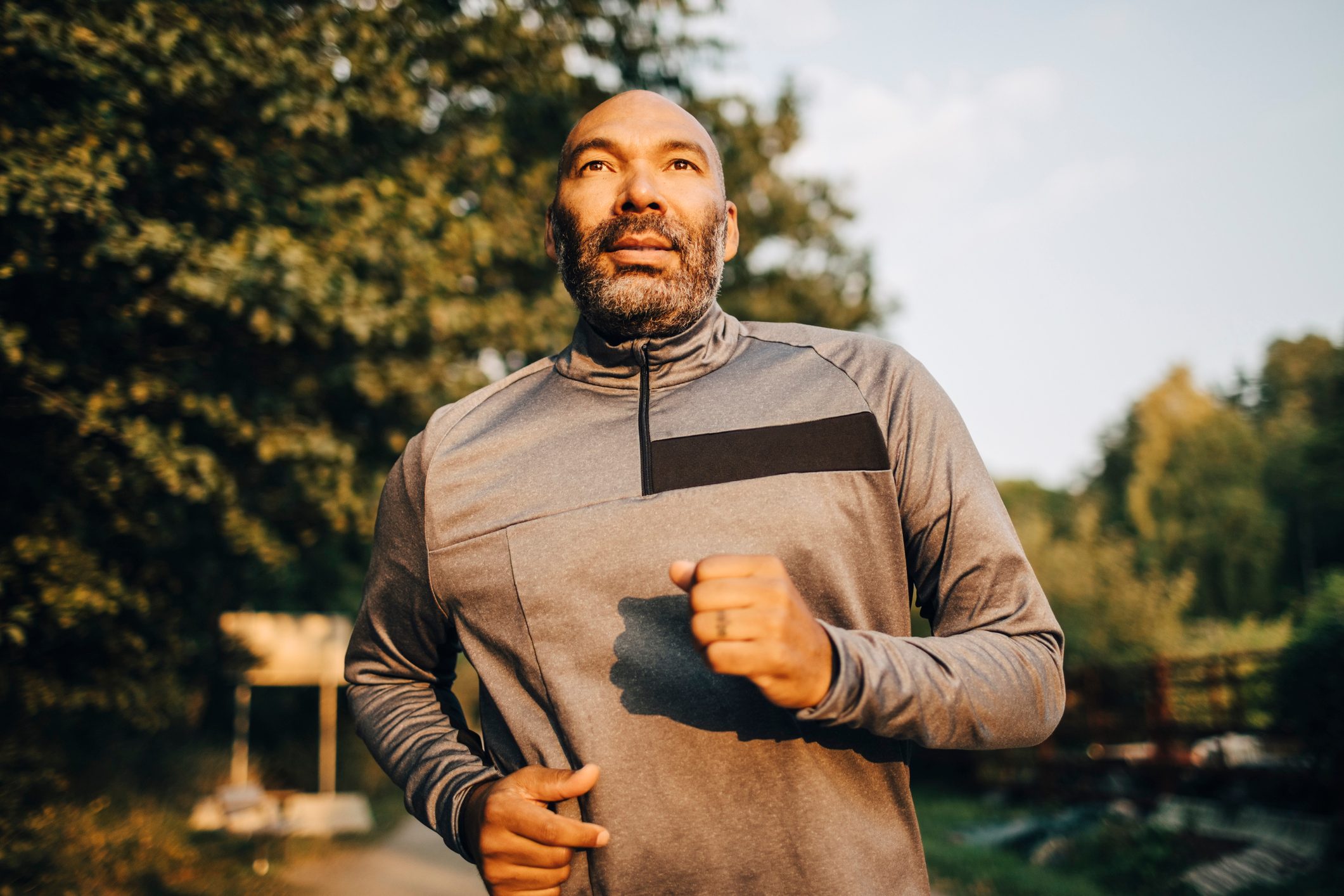 Man jogging in park during sunset