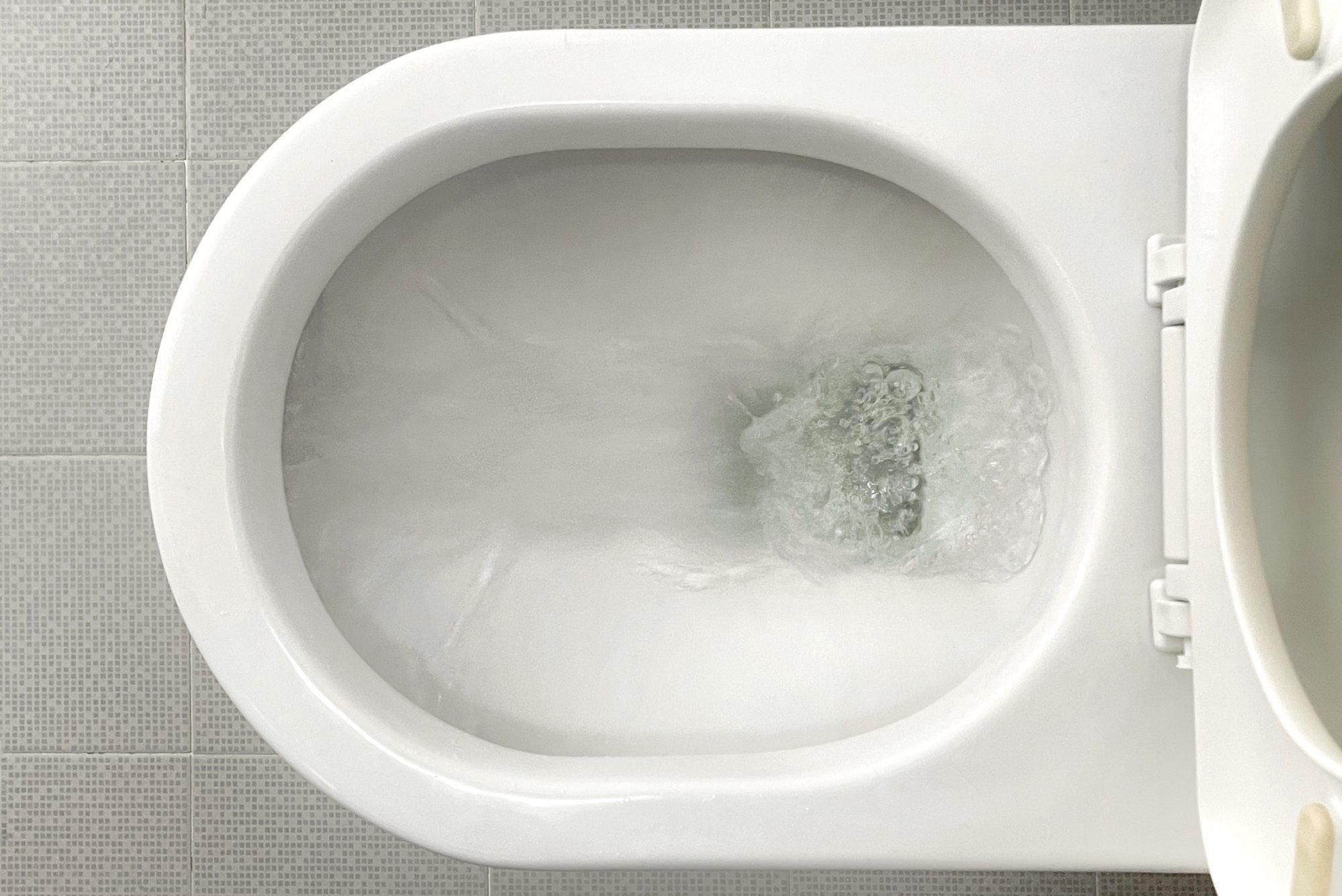 Water flushing down toilet bowl