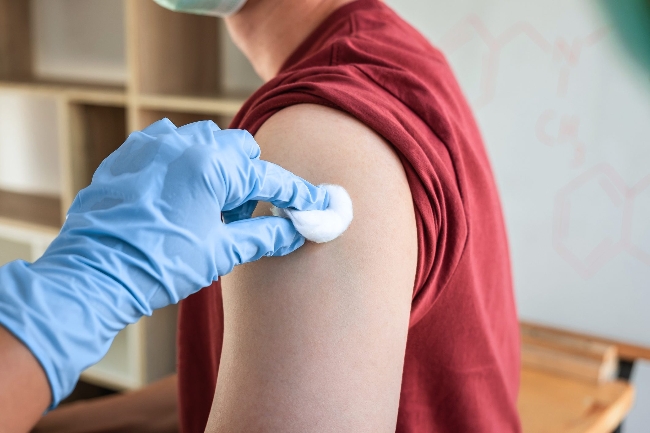 Midsection Of Woman Getting HPV Vaccine In Hospital