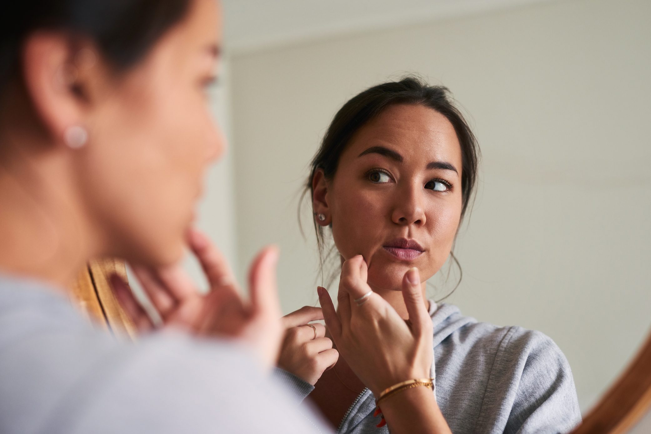 woman looking at herself in the mirror