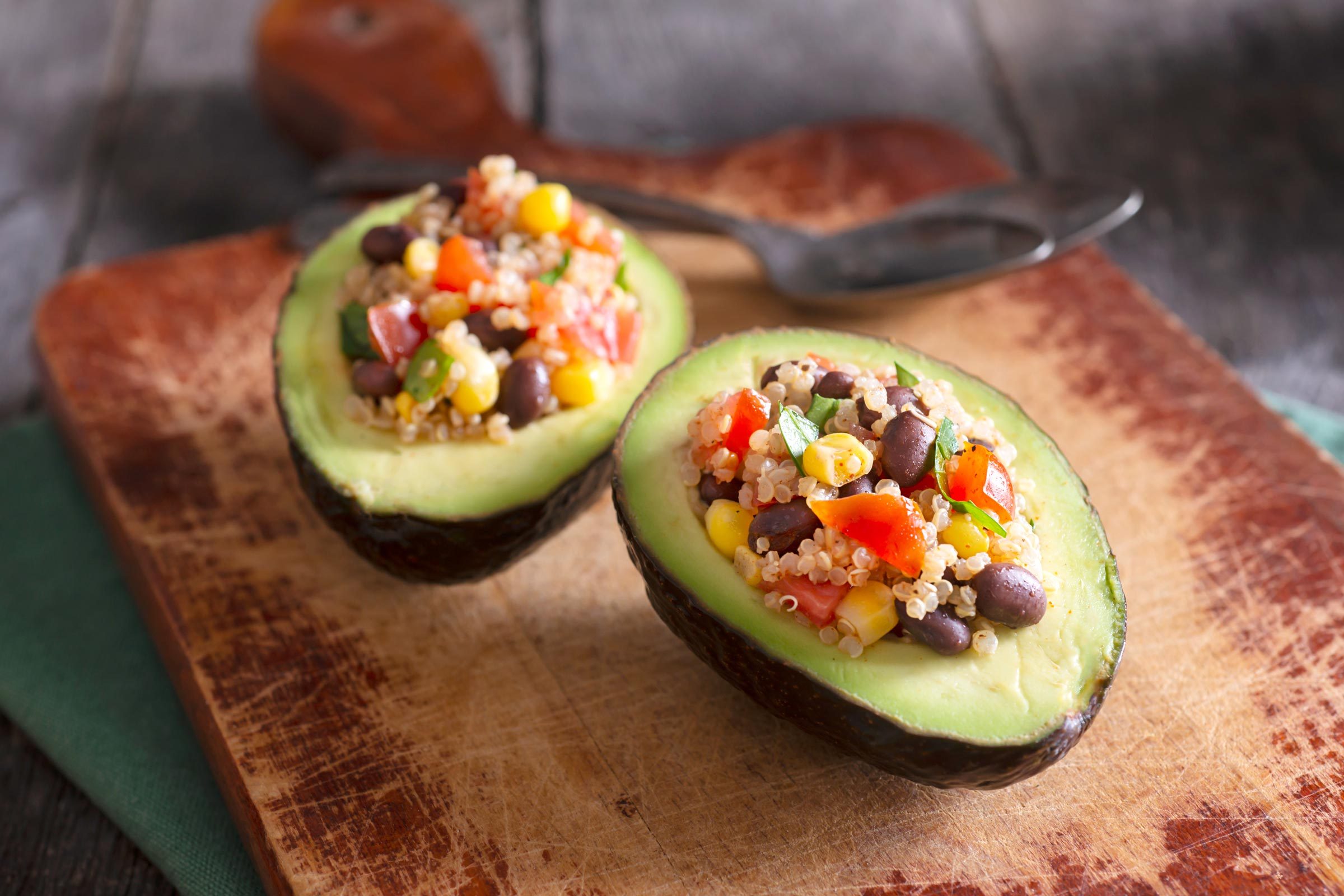 Avocado stuffed with quinoa, black beans, corn, tomato and cilantro