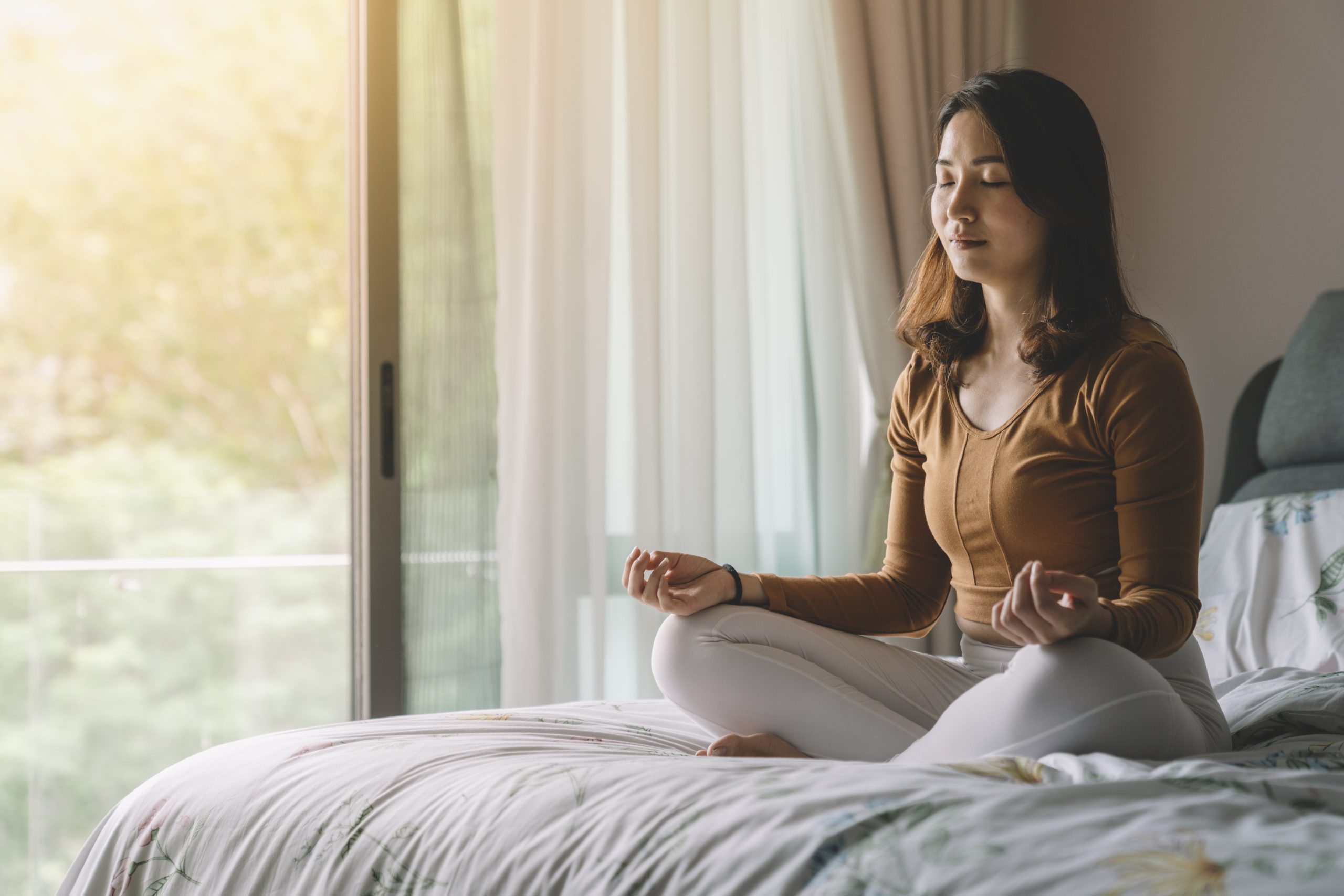 Asian Chinese Woman Meditating At Bedroom