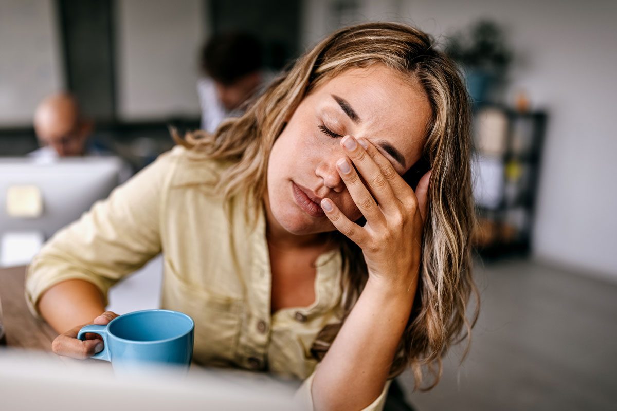 Tired Business Woman Rubbing Eyes